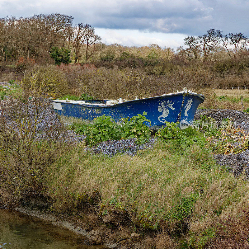 Old boat stranded in the marshes of the town of Assérac en Loire in Atalntique on the border with Brittany